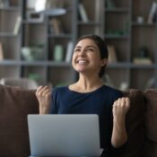 Overjoyed young woman celebrating getting good news