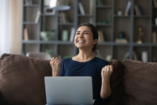 Overjoyed young woman celebrating getting good news