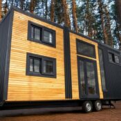Modern tiny house on wheels with wooden exterior.