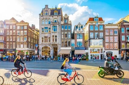 Damrak street in central Amsterdam, people cycling