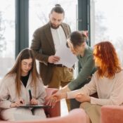 A team of diverse business people discussing work, planning strategy and collaboration in a modern office lounge