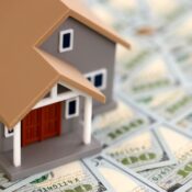 Toy house on big amount of US dollar bills