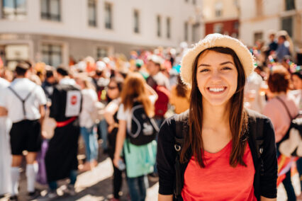 Cheerful tourist visiting to the public celebration