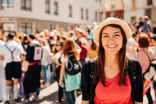 Cheerful tourist visiting to the public celebration