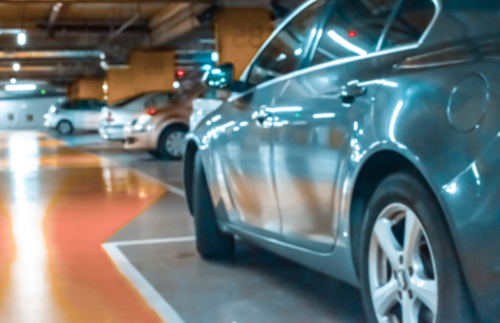 Cars parking in underground airport carpark.