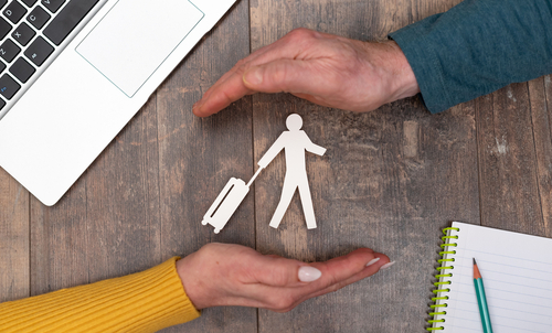 Concept of travel insurance with hands in a protective gesture