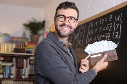 Teaching showing a full wallet in the classroom