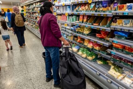 Customers in a supermarket making careful choices as food inflation hit a record high.