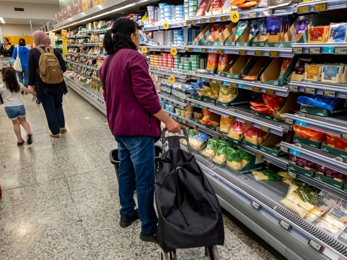 Customers in a supermarket making careful choices as food inflation hit a record high.