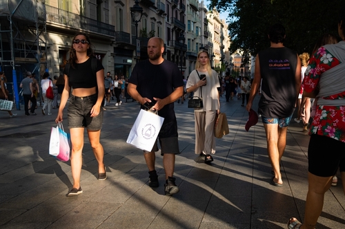 People is seen shopping in the city downtown and shopping street Carrer de l'Angel in Barcelona, Spain