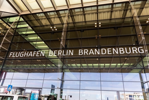 Glass modern facade entrance view Berlin Brandenburg airport logo outdoors new terminal building.