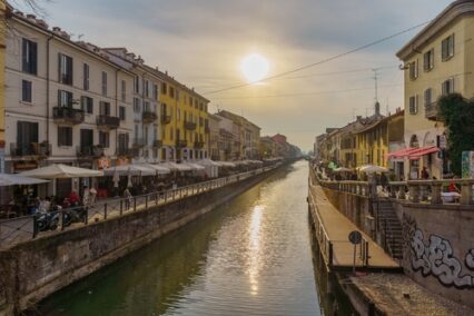 View of the Naviglio Grande canal, with locals and visitors, in Navigli, Milan, Lombardy, Northern Italy