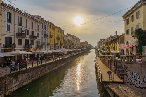 View of the Naviglio Grande canal, with locals and visitors, in Navigli, Milan, Lombardy, Northern Italy