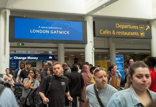 People queue to check in for flights at London Gatwick Airport, South Terminal, UK.