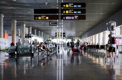 Passengers and tourists walk towards the departures boarding gate of Las Palmas de Gran Canaria Airport
