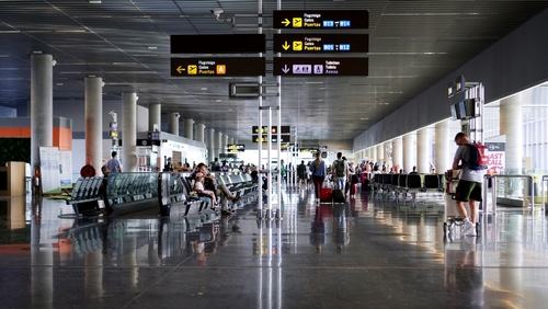 Passengers and tourists walk towards the departures boarding gate of Las Palmas de Gran Canaria Airport