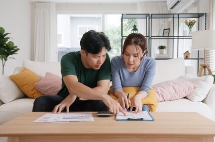 A couple calculating the cost of their bills