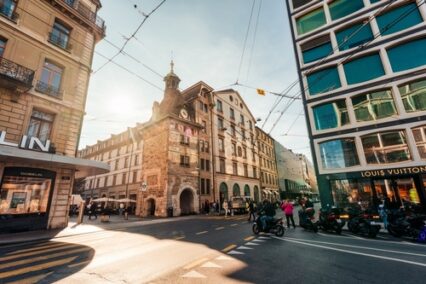 Contemporary building exterior with brand name store, tram transport and street view in shopping centre