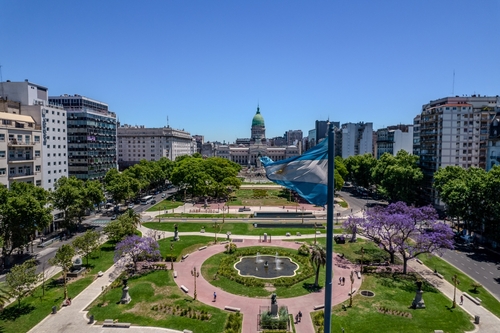 Beautiful aerial view of the Argentina flag waving, the Palace of the Argentine National Congress, in the city of Buenos Aires, Argentina
