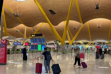 People carrying luggage in the Barajas Adolfo Suarez International Airport in Madrid during the summer vacation. Spain.