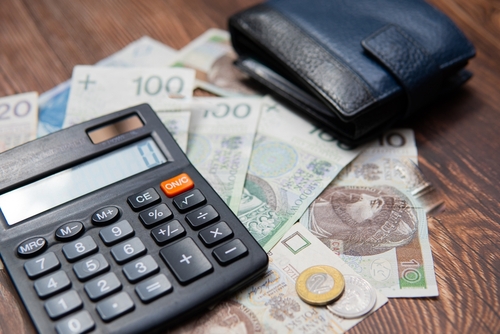 Polish zlotys next to a calculator.
