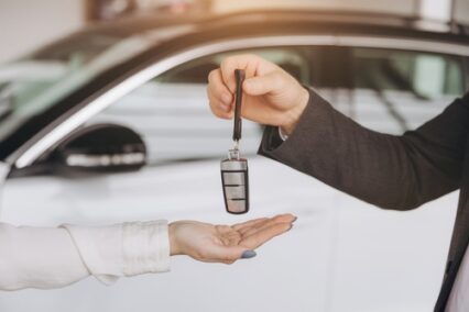 Man handing car smart key. Car rental. Car sharing.