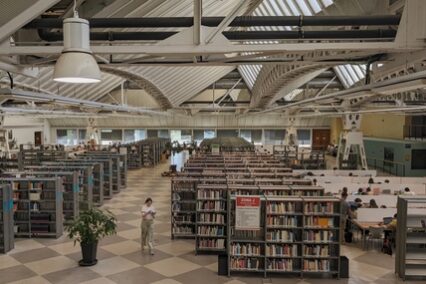 Inside the library of Pablo de Olavide university - looking down from above - on the right students studying at tables