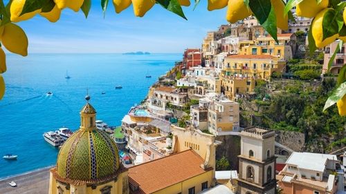 Picturesque Positano on Amalfi Coast, Italy, showcasing colorful houses on cliffs and stunning blue waters of Mediterranean sea.