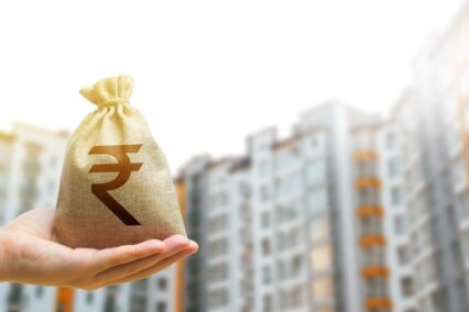 Indian rupee money bag against the background of modern high-rise buildings.