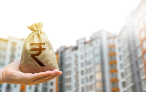 Indian rupee money bag against the background of modern high-rise buildings.