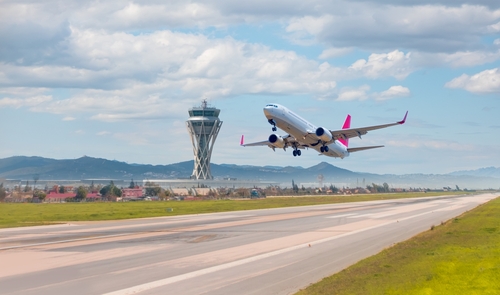 White passenger plane takes off from the runway of the airport - El Prat-Barcelona airport.