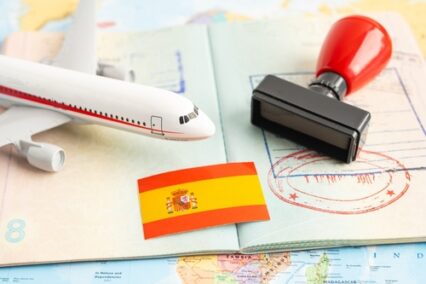 Approved stamped passport with Spanish flag document for immigration at airport in land.