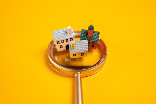 Houses on a magnifying glass.