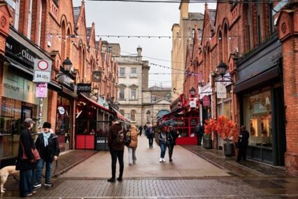 Castle Market Street in Dublin with shops, restaurants and people walking on a rainy day, Ireland