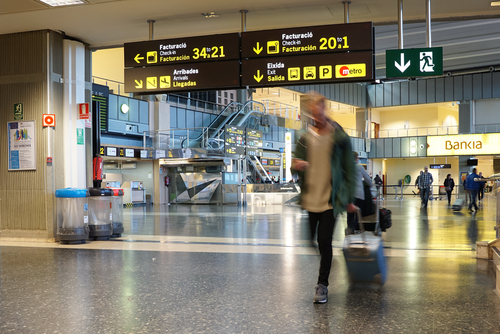 Airline passengers arriving inside Valencia Airport.