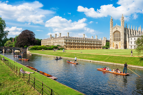 Tourists on punt trip along River Cam near Kings College in the city of Cambridge, United Kingdom