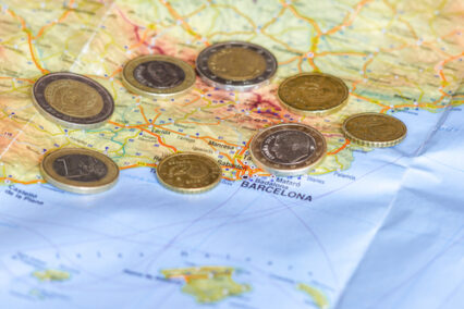 Spainish Euro coins are seen over map of Catalonia region in Spain.
