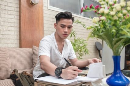 A freelance assistant or writes down some notes, working at home.