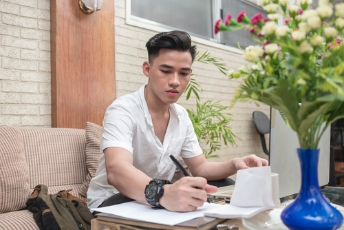 A freelance assistant or writes down some notes, working at home.