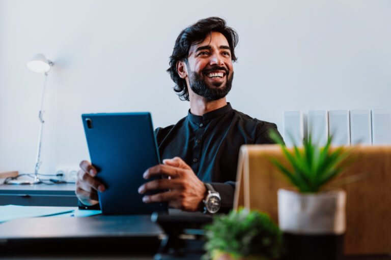 smiling freelancer at a desk