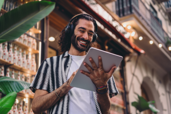 smiling man with touchscreen tablet in India