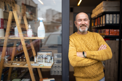 male business owner in france outside shop