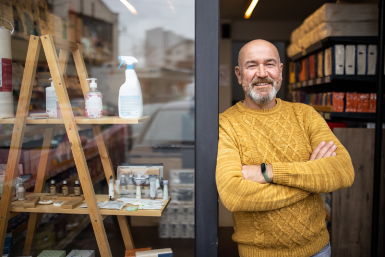 male business owner in france outside shop