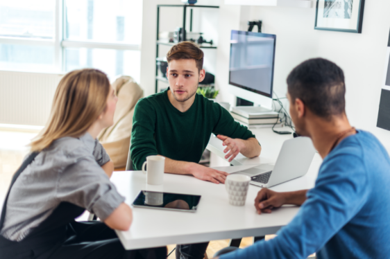 three-person team working in office