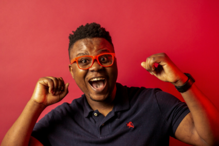 happy man with colourful red background and red glasses
