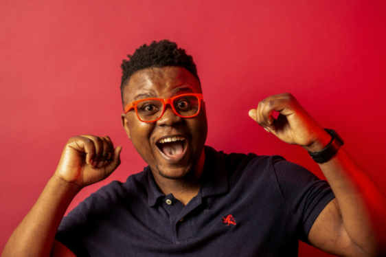 happy man with colourful red background and red glasses