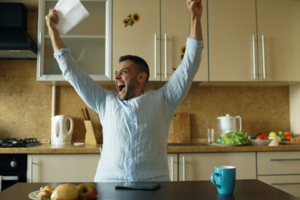 man celebrating happy news at home