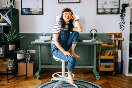 happy woman sitting comfortably in studio