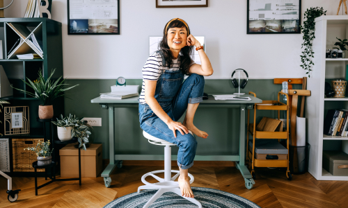 happy woman sitting comfortably in studio