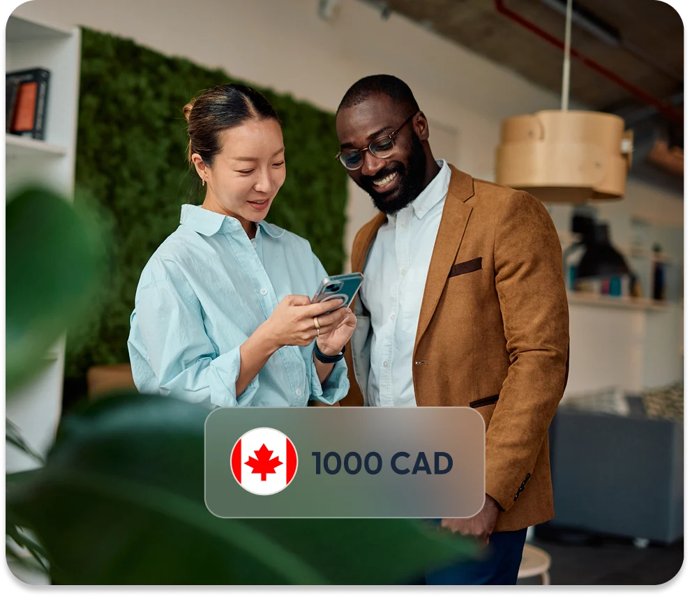 Two colleagues reviewing a payment on a phone